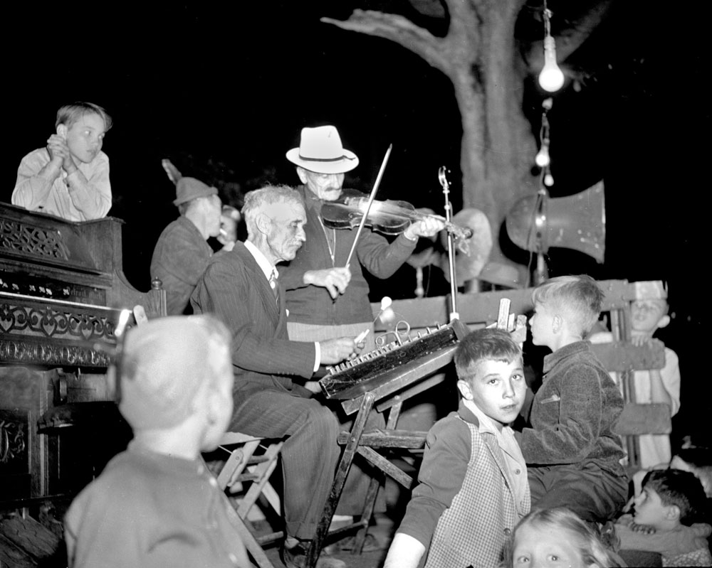 Saugatuck, Michigan music on the square, c. 1948. The musicians and the children are captivating on a humid July Saturday evening. Photo by Bill Simmons. View full size.