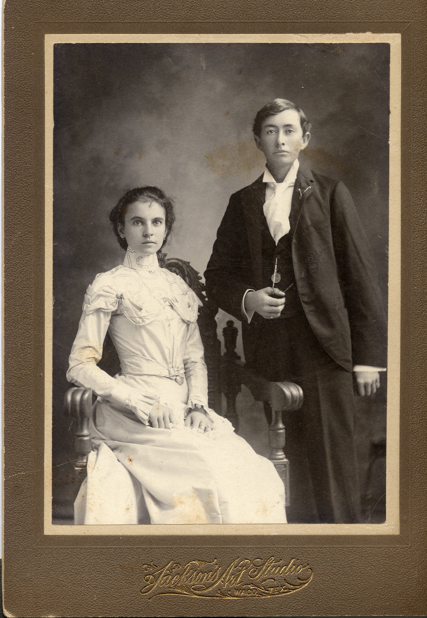Mr & Mrs James Granville Stovall (nee Loretta Roan Wayland), who were married at Christmas time, 1899.  They lived in Limestone County, Texas but went to Waco, to Jackson Studio, to record their newly married state and some obvious prosperity. This is another portrait taken at the same time as the more traditional pose of the gentleman seated and the lady standing.  They are my maternal grandparents. 
