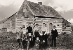 Taken about 1902:  The Foley Family poses outside their log home, built circa 1847, located on Keenan Road in the Helena area of upper New York State, Saint Lawrence County.

Standing (left to right): Herbert John Foley (born Jan 26, 1892), Herb's mother, Aunt Kate McCarthy, Miss Hurley (a dressmaker who helped get everyone ready for the picture), Herb's brother Jim and his brother Bernard

Seated: John Henry Foley (Herb's father), brother Tom seated on his knee (whose name was changed to Fr. Bernard when he was ordained a priest), sister Anne (on stool), Herb's Grandmother Foley whose husband Dennis came to this country from Ireland with his father Dennis, and his brothers, Patrick and Jeremiah.  

Herb is my grandfather.  It's odd that his mother isn't even mentioned by name and yet both the aunt and the dressmaker are named.  I guess not too many people smiled for pictures back then!

Submitted by Jack Foley of Ashburn, Virginia
