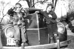 Photo taken on Washington St. in Freeport IL circa 1950. Why do pretty girls like to sit on car fenders? View full size.
(ShorpyBlog, Member Gallery)