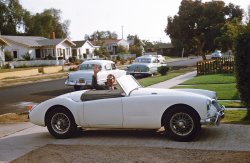 Chula Vista, California, 1958. Grandpa Fred in his MGA on Madrona Street. Photo by my father, home on leave after his second year at West Point. View full size.
MeanwhileThe middle class British family car was this an Austin A35
Impressive!
  That is quite a vehicle.  I read up a little on it and was surprised to find out that it was actually raced in Nascar in the early sixties.
Street view today..Appears Grandpa Fred lived at 231 Madrona.  Street is not as nice today as back in '58.
View Larger Map
Gotta love Gramps!I bet he must have been 50 or so. Got his jaunty little sports car. For sure,not an old guy on the porch in his rocking chair. Just from the picture,I bet he was a fun loving guy who enjoyed life. Is there any cahnce he is still alive?
The Usual CadetCadets at the military academies seem to always buy sports cars. Someone put a nice gash in his front fender. At least he is having fun.
MGs"MGs.. Turning drivers into mechanics for half a century!" I had a college friend who drove a yellow one, his dad had a black one. I'd bet that the two cars were both up and running at the same time maybe three months in the years I knew them. They were cool cars when they were fixed though.
Gramps&#039; well-used MGAShows signs of daily-driverness. As opposed to garage-queenliness, with that crease down the side and the overflow of grease from the front wheel bearings. The MGA was a decent car, actually outran some contemporary Porsches in Sports Car Club of America races at Palm Springs, as documented in the magazines of the time. I have attached a photo of one racing at Willow Springs "vintage" races in 2004. My brother had one which he crashed into a boulder at the side of a highway near Big Bear Lake, California.
I worked in Chula Vista for quite a few years. I probably jogged or walked down that street at lunch breaks in the 1970s and 1980s, although I don't recognize the houses.
That MG is one of those real MODERN ones.Here I am fussin' with an MG-TD that same year. Then came the TF and then the ultra swoopy high-powered (72 horsepower!) model sported above by David Wilkie's Grandpa. When Truman Capote's book "In Cold Blood" was made into the film with Robert Blake, I always thought the guy helping me put the top up - or was it going down - looked like Blake. Or the other way around. 
Man About TownGrandpa looks to be quite the bon vivant! 
The Lucas motto: &quot;Get home before dark.&quot; The reason for the joyous countenance is because he expects to be home before dark. The Lucas headlamps had three settings: dim, flicker and off. Had a 69 Triumph TR6 motorcycle with Lucas electrics. We had a serious love hate relationship, but when she was running right it sounded like the Boston Symphony. 
The MGs were all a joy to drive, and notwithstanding the remark above, gramps bears witness to that proposition. Regrettably, I never owned one. The spoke wheels are quite handsome. 
Looks like he left the 54 Plymouth and 1951 98 for the youngsters. 
Really?I could be a grandpa by now, but that grandpa looks nowhere near 50. Mid 40s at best. 
Ground view todayIn 1958 I was living with my folks about a mile northwest of this block, and, strange to say, as I write this, I'm in the process of slowly moving back in again to that same house. With that classy MG, you grandfather looks like he was probably a customer at my folks' steak and seafood house, one of only three or four "nice" places in town back then. In 1958 Chula Vista was at the top of its boom years, with the Navy and huge Cold War aerospace payrolls keeping everything pretty prosperous, expanding rapidly and definitely optimistic (Rohr Aircraft Corporation's  28,000 workers on three shifts, producing fuselages and missile parts). But CV's economic Big Chill set in pretty early, although it took decades for it to really show. By 1963, three-fourths of the Rohr payroll had moved permanently to Marietta, Georgia, never to be successfully replaced. That being said, Madrona Street doesn't really look all that bad today, although fewer residents are as "yard-proud" as they once were. And, Chula Vista has annexed so much formerly unincorporated land to the south and east that it's now the second largest city in San Diego County, with 56 square miles of mostly newer neighborhoods.
MGA, MGB, Triumph, Morgan etc. Were/are British "sports" cars popular in the USA - they never struck me as ideal transport - your bum's too near the road! Perhaps more of a bird-puller?
Jos. LucasSince we started Lucas jokes:
Did you hear that Joseph Lucas got "Honors" from the Queen?
He is now know as the Lord of Darkness!
Why do the British drink warm beer?
Lucas makes the refrigerators as well!
Running great 55 years later.I still own the used 1957 MGA my parents bought my sister back in 1962. It was later abandoned by her, and left in the bushes gathering dust and mice. I always asked my parents not to sell the car, I was interested in getting it running myself. So, at 14 years old, I read the Chilton's manual and went to work. Lo and behold, late one night my mother hears the sound of the engine running once more. Even at that age,I was allowed to drive it around the back roads of the county as my reward, and have owned it ever since. I rebuilt the engine myself at 18, and can say that if you tune them correctly, they are as reliable as any vehicle of that vintage.
At 19, I rebuilt the engine and painted the car. A few years later, she was put into the parents garage with the promise to drive her every couple of weeks or so. Weeks turned into months. Months turned into years. After sitting well over twenty years, I promised I would get her running again before the end of the millennium, which I did. The sound and smells that car produced as she warmed her heart after all those years brought the memories streaming back. Much like this photo did as well. Thanks Shorpy.
On the popularity of British sports carsHaving owned/put up with a few British sports cars back in the late 1950s to mid 1960s, I can say that we bought them not to troll for la femme but to drive the darn things. This is not to deny the attention they gathered from la femme, especially the E-Type Jaguar. Here's my Jag (in Altoona, Pa.) plus one of my Healey 3000s (Wildwood, N.J.) and the TR-3 Triumph I raced (Thompson Raceway, Connecticut). I had other sporty cars but only a total of four Brit cars (replaced one Healey with another one). Yes, we had The Fun, we really did. (Cue Jim Croce's "Time in a Bottle".) Sigh.
Lend-Lease: the SequelBritish sports cars were definitely popular in the USA, especially in the 1950s and '60s.  When I was in college in the latter decade, I drove a 1956 Austin-Healey 100-4, a corporate sibling of the MGA featured here, which it resembled in basic profile.  My Healey had been well-used long before I got it, and often enjoyed a symbiotic relationship with my father, an experienced auto mechanic, but ran well enough most of the time that there was nothing like it -- having my bum tooling along a few inches off the road made the exhaust coming out of the tailpipe right behind me sound that much sweeter.  And of course my Healey was a "bird-puller" -- I had that in mind from the first moment I spied it on the used-car lot, and I must say it worked, too.  Thanks for these top-down memories.
Dad...My dad had at various times in the early 60's, an Austin Healey, a Triumph TR3, and something I think he called a 'Bug-Eyed Sprite'. He loved those cars but they were headaches for him as well. I remember he told me that one time a wheel actually fell off the Healey while he was driving down the road. My wife's uncle had an infatuation with TR7's and possessed 5 or 6 of them at the time of his death.
No Chance.He would be way over a hundred if he was still alive.
I lived in Southern California, from 1956 to 1959, near Pasadena in a little town called Duarte. For a young lad (11 Yrs Old),who migrated there from the big blue sky's of Texas, it was not a nice place to grow up. The smog was so bad (I lived in the foothills of the San Gabriel mountains), you were lucky to see them on a Sunday. I was definetily glad to leave.
Know why the British didn&#039;t make computers?They couldn't figure out how to make them leak oil.
The first car I owned was a 1967 Triumph Spitfire.  I couldn't keep the rear tail light lenses on the car, everytime someone would walk around the back, they would naturally grab ahold of the tail light lens and it would break off.
In 1970 the lens cost $11.00 and was a special order item in Springfield MO
I wonder if your family knew mineMy mother graduated from Chula Vista High in 1958 and lived on 1st  near Shasta St in Chula Vista. I wonder if anyone in your family knew her. Linda Lane is named after her. It's great to see a picture of what the area looked like then. My mother said she remembered in the late 40s that there were still lots of lemon groves and there was a guy who delivered produce with a donkey cart.  
(ShorpyBlog, Member Gallery)