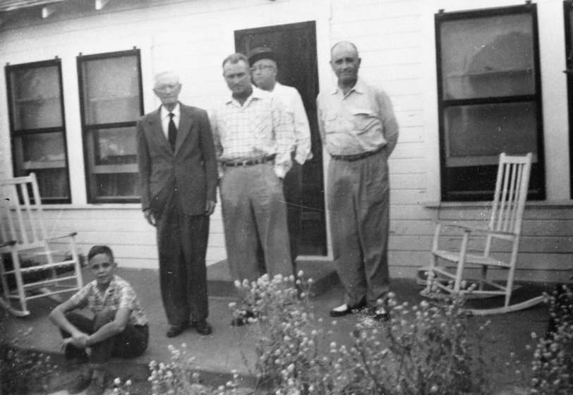 This is me, Edward Mitchell, in 1955 on the front porch of my paternal grandfather's home on South Third St. in Waco, Texas.  Left to right is George Washington Mitchell, 88, who became a widower in 1954 after over 60 years of marriage.  These are three of his five sons, not including my father who is in the house and the middle son Ross who died in 1952 at 52.  Lloyd, 48, high school teacher and football coach, Arthur, 61, Ford dealer since 1925, and Ralph, 51, Inspector for Texas Dept. of Health. Granddaddy had a massive heart attack in summer of '54 and lingered at the point of death for three weeks.  He then recovered, went back home and lived to be 93.  I spent virtually every Saturday night with him between '55 and '61 when the man my mother and aunt hired to live with him left for the weekend.  We'd watch Gunsmoke, People Are Funny, Lawrence Welk and Groucho Marx on his metal '54 Firestone TV.  I'd play his Victrola and he'd tap his cane in time to the music.  I'm retired after working 30 years in the oil and gas industry. View full size.

