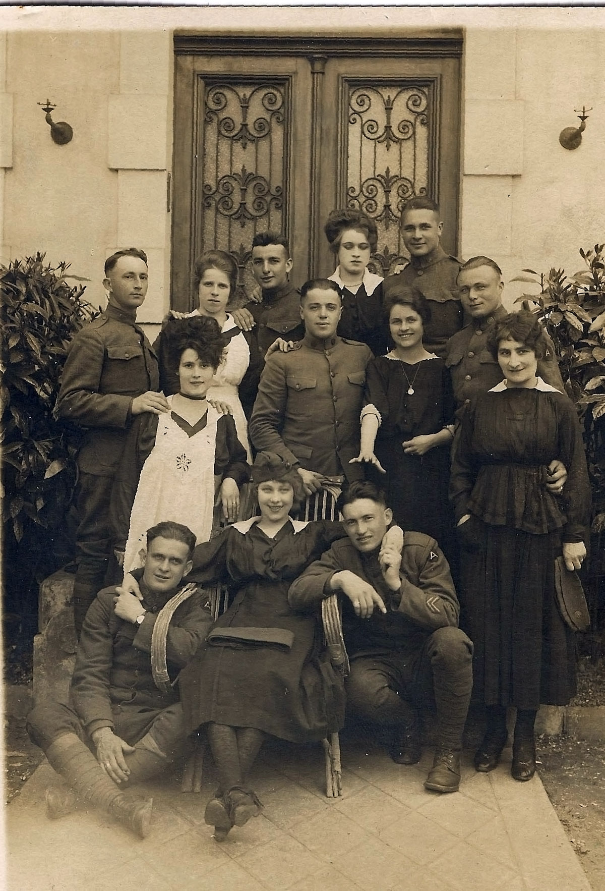My grandfather (standing far left) and friends in France during WWI posing with some of the local French beauties. View full size.