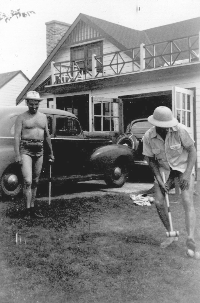 The person who took this picture (in the early 1940's) intended it to be a picture of their two fellas having a fun afternoon playing croquet. But we all know the two stars of the photo are the two cars behind them. From a photo album found in a second hand store in Lancaster, California. View full size.
