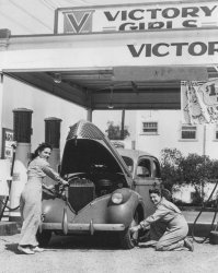 Taken in Los Angeles, Calif., 1942. During World War 2 there was a man shortage on the home front so these ladies replaced them for the duration. View full size.
Three gallonsI would bet there's an "A" sticker on that car's windshield. This meant you got three gallons for the entire WEEK. You also had to drive at "Victory Speed"--35 MPH, no more.
WillysI would place the car as a 1941 Willys. They were small cars, with a flathead 4 cylinder motor but later became very popular later as hot rod bodies in the 50's and 60's.Especially the coupes and 2 doors.
(ShorpyBlog, Member Gallery)