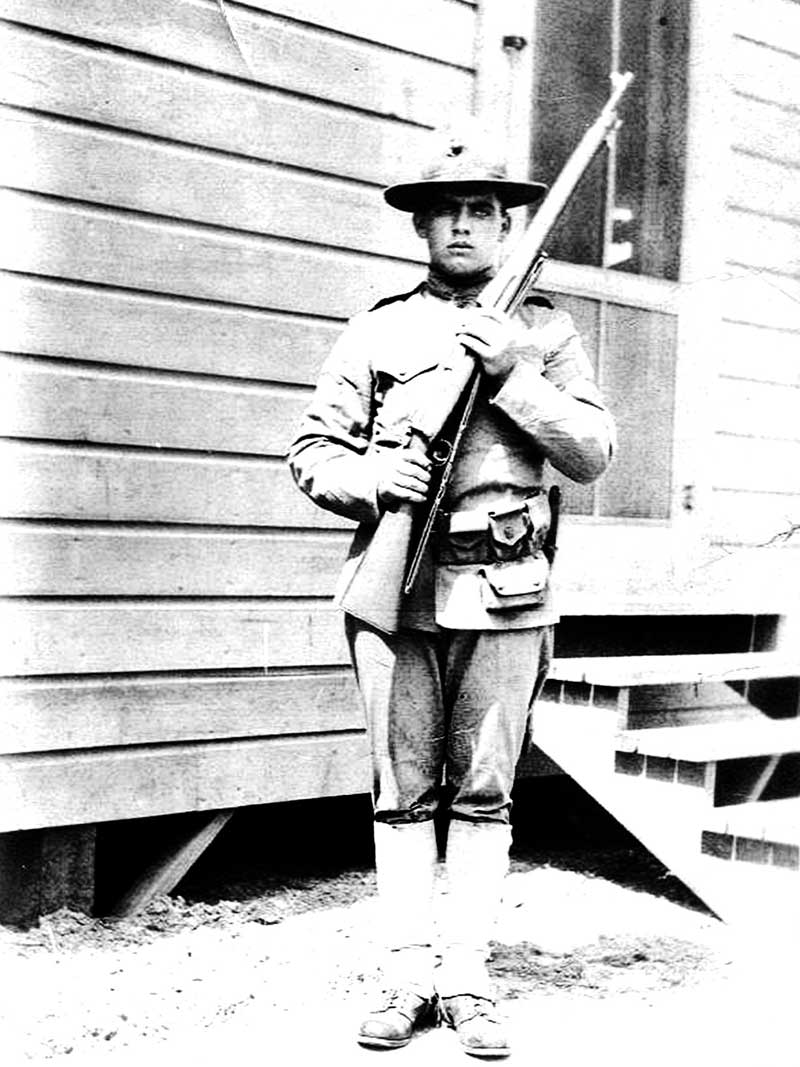 George Merrill Woods in WWI uniform. He is the brother of James Harrison Woods who was posted on Shorpy previously. I think the uniform is Marines, but I remember my grandmother telling me he was in the Navy. He is over seas, I know not where. Many thanks to someone who could confirm the uniform? View full size.