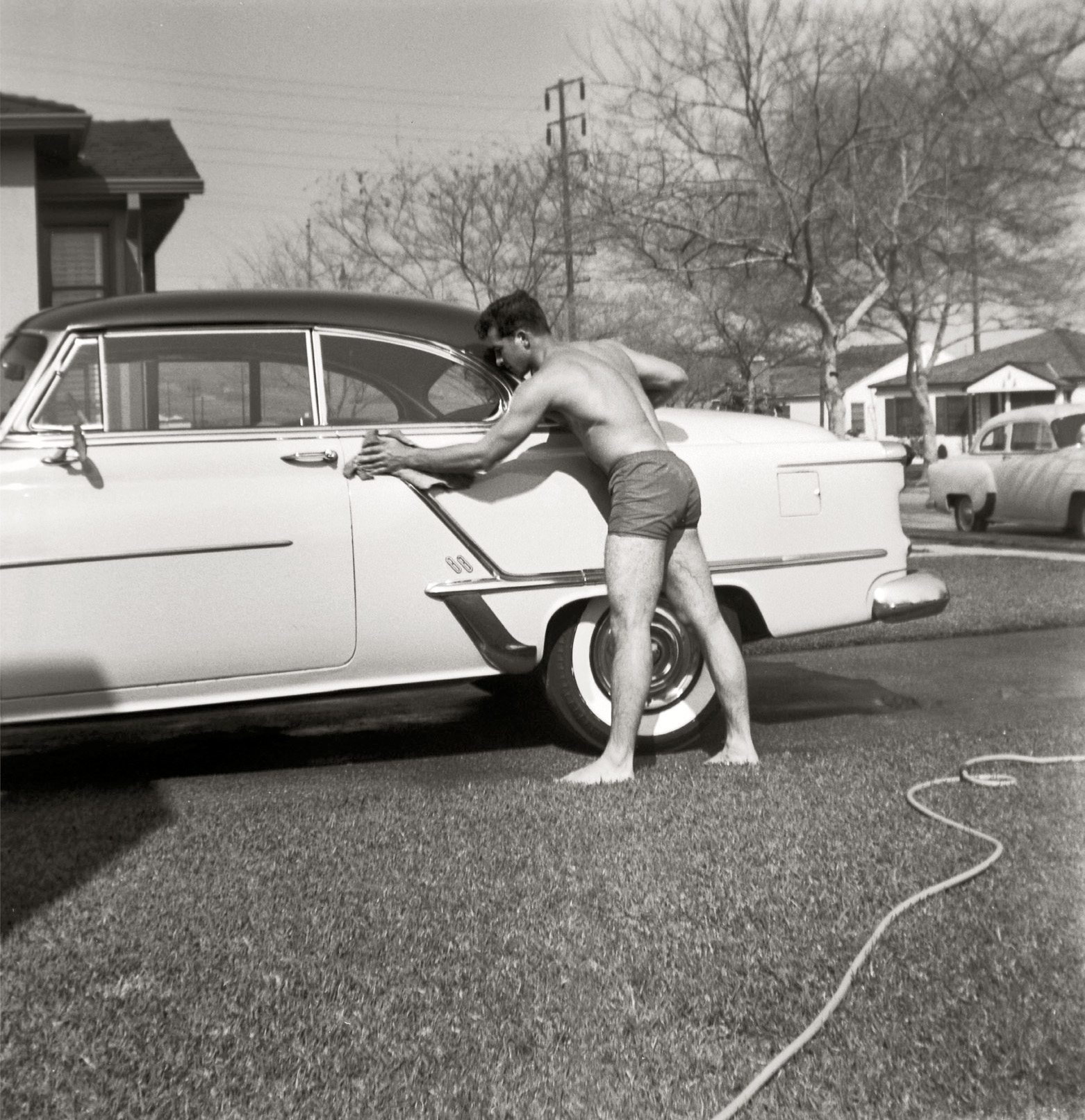Grandpa washing the Oldsmobile. This was taken during the mid '50s in Los Angeles. Scanned from a medium format safety negative. View full size.