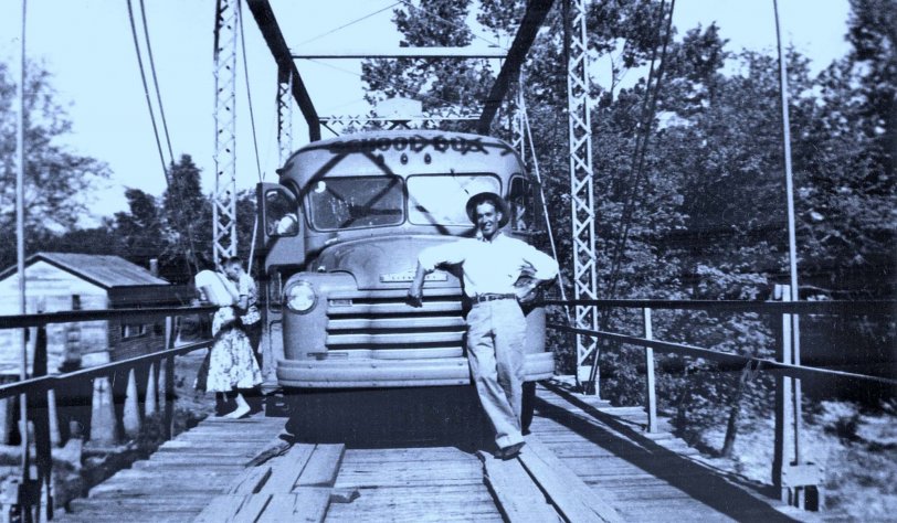 My grandfather on my father's side drove the school bus in Christian County, Missouri for many years. This is him leaning on the hood of his school bus in about 1950. 

His route crossed the Riverdale bridge that was built in 1906-1907, and he would sometimes stop to let the kids admire the view of Finley Creek. He would take me fishing below the old powerhouse visible on the left of the photo when I was a child. 

The old bridge was replaced several years ago with one that allows two cars to pass at the same time, but has no character. The powerhouse and the old store across the road (not visible behind the bus) have both been fenced off as private property. View full size.