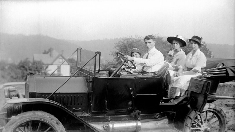 This is my Grandfather behind the wheel of a car, probably in or near Coraopolis Pennsylvania, 1915. The woman behind him holding the baby is my grandmother. The baby she is holding is my Aunt Ange, who just passed away this week at age 96. I wanted to share this to honor her life. My grandparents were Italian immigrants, and this is from a set of glassplate negatives that were found in my grandfather's attic after he moved to a nursing home around 1980. Does anybody know what kind of car this is? View full size.
