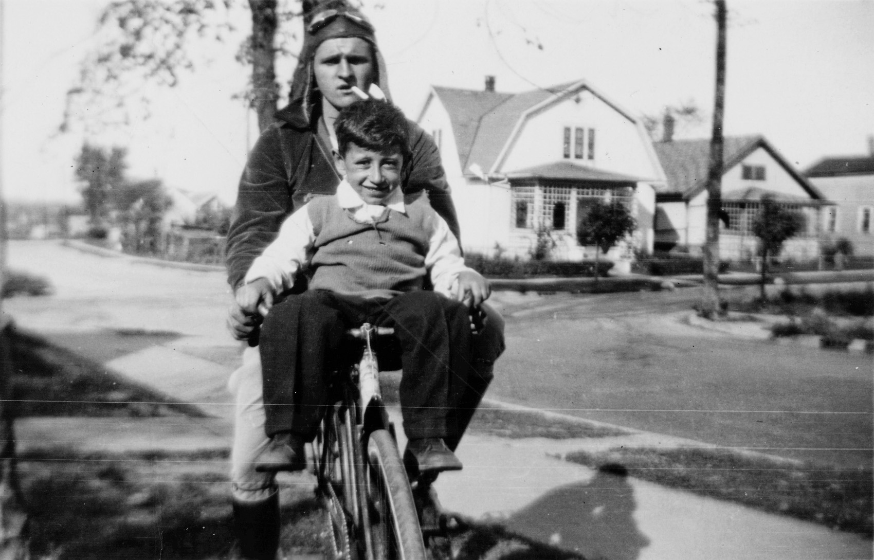 That's my great grandpa riding the bike and his little brother Pete on the handlebars. This is probably the early '30s in Illinois. View full size