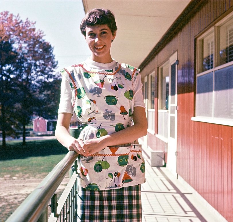 My wife in 1957, just outside our apartment B-6, located within the Pine Grove Terrace complex for married students at Eastern Michigan University in Ypsilanti. This apartment was just what we needed for our senior year in college. These apartments have since been razed. View full size.
