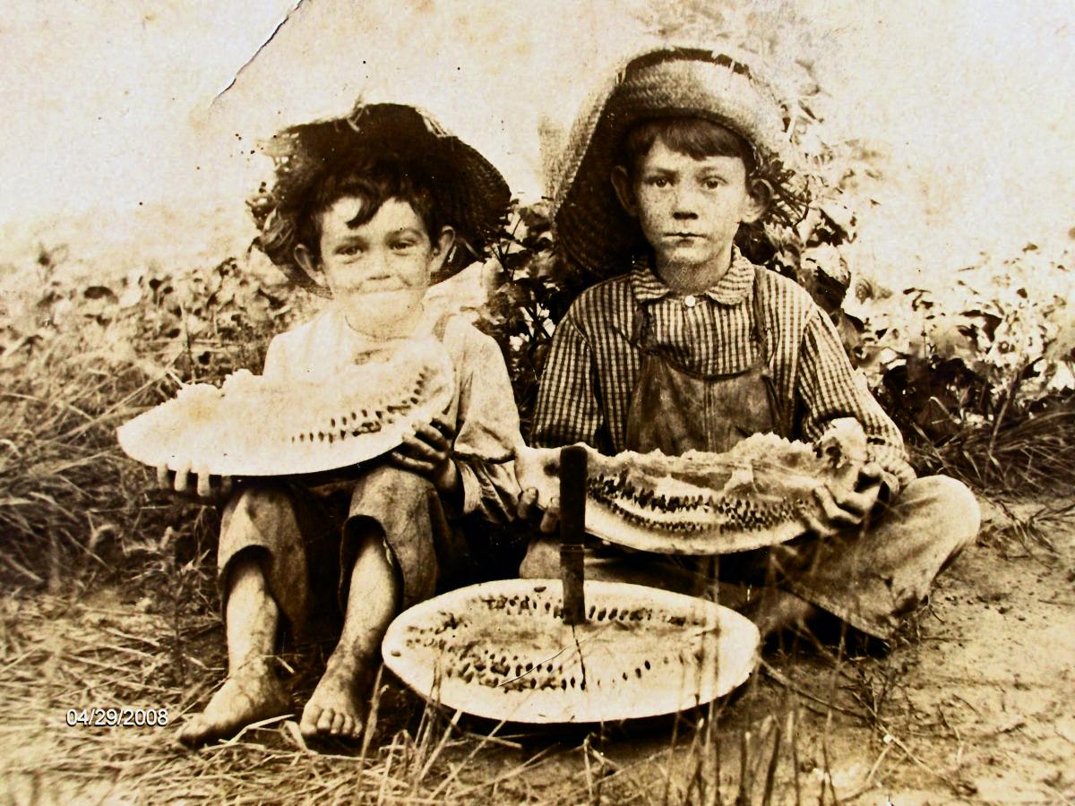 That is some good looking watermelon! I'm not exactly sure who these kids are; but they're in Perry, Oklahoma, and it's the late 1890s or very early 1900s. I found this photo in my collection from my Granny Annie, so at least one of the kids has the last name of Keeler. It reminds me of a song she taught me...
  Fried chicken is mighty mighty fine
  But nothing could be finer than a watermelon rind
  So plant a little watermelon on my grave
  And let the juice (slurrp) 
  Trickle through!
View full size.