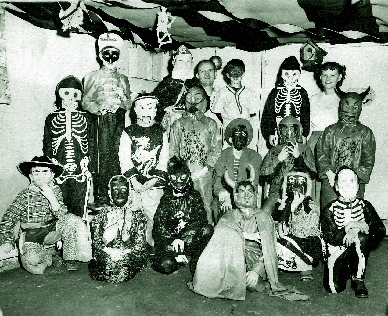 A group of neighborhood kids at a party in N.E. Pennsylvania.  During Halloween in my town at the time, when you trick or treated you were invited into the house and had to perform something (usually a song) to earn a reward of a penny or two. View full size.