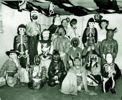 A group of neighborhood kids at a party in N.E. Pennsylvania.  During Halloween in my town at the time, when you trick or treated you were invited into the house and had to perform something (usually a song) to earn a reward of a penny or two. View full size.
(ShorpyBlog, Member Gallery)