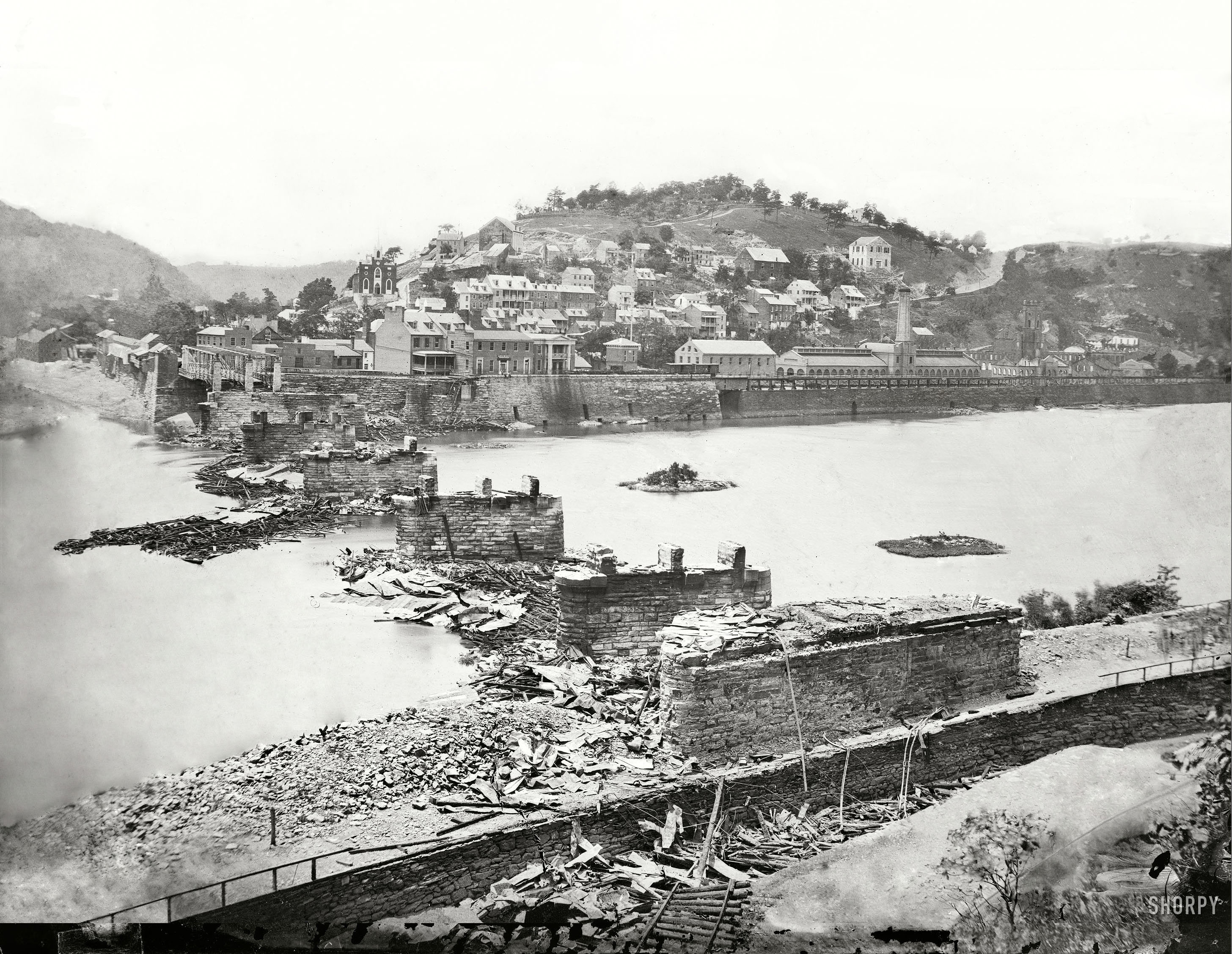 Restored picture of Harpers Ferry: 1862 --- "Harpers Ferry, West Virginia. View of town; confluence of Potomac and Shenandoah rivers; railroad bridge in ruins." Battle of Harpers Ferry, September 1862. Wet plate glass negative by C.O. Bostwick. --- The original photo can be found here.

I spent a lot of time making sure that this restoration was accurate. I was able to find pictures and drawings from around the same time and used those as a reference. View full size.