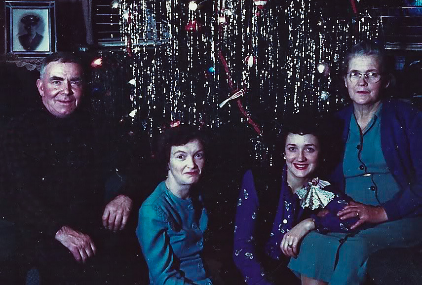In this Kodachrome picture are the McGough family of Highlands, New Jersey, having their Christmas portrait made. Everyone is home for Christmas except for one person, Lawrence McGough, who was serving overseas as a B-17 bomber crewman. Note the picture of Lawrence in uniform in the background. View full size.
