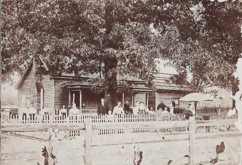 This is a picture of my great-great-grandfather's home, believed to have been taken in the late 1800s. The man on horseback is believed to be my great-grandfather. Some of the people pictured are neighbors.  We had to have the house torn down in the 1970s after it was heavily damaged by lightning. View full size.
