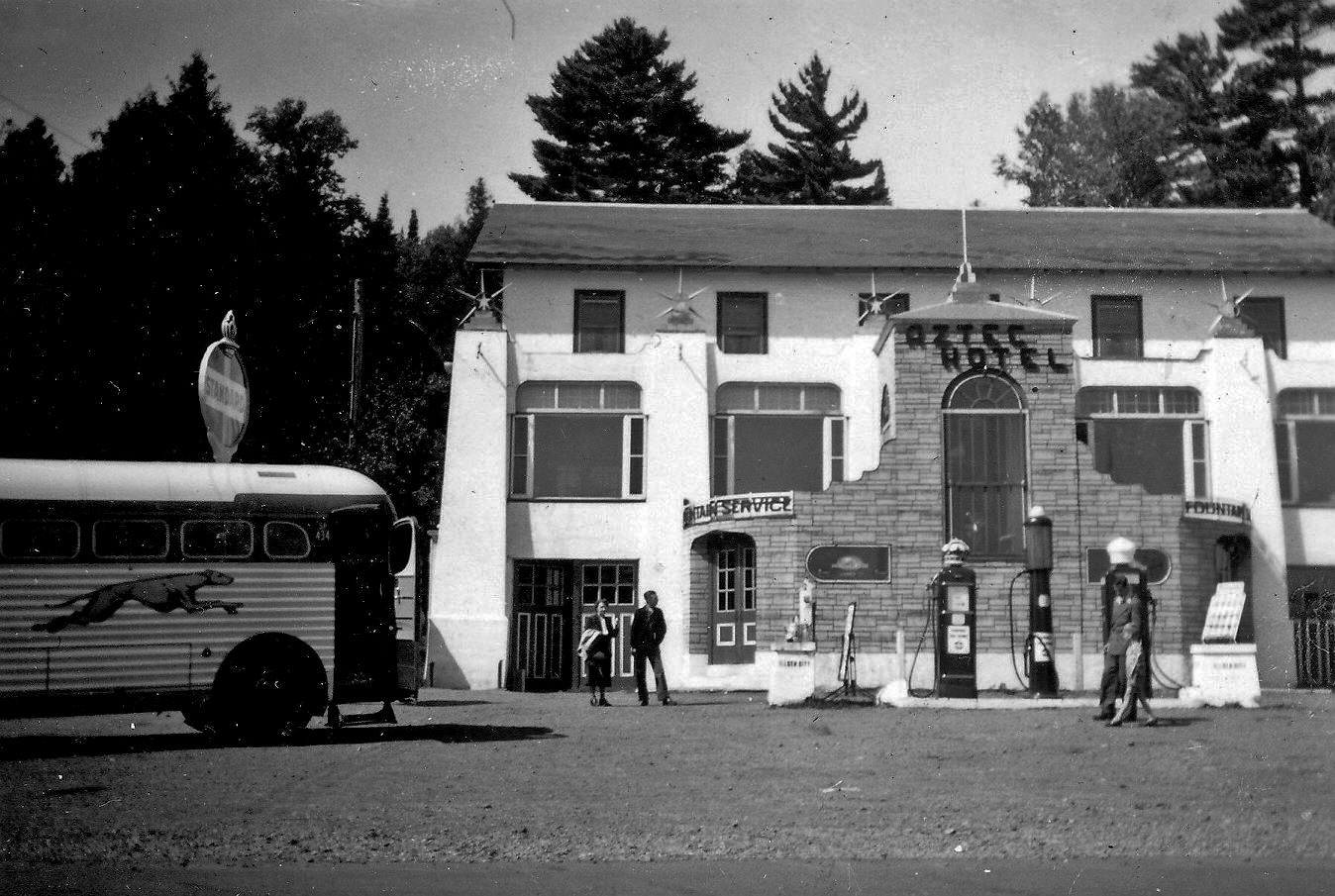 My father and I are in the picture in front of the gas pump on the right in 1949 when I was five. The Aztec Hotel with its memorable soda fountain was about half way between Fort William (now Thunder Bay), Ontario and Duluth, MN. The main highway is 61 and the turn off at the Aztec is Hwy 1. You would turn here to go to Ely, MN. This drive along Lake Superior is noted for its exquisite scenery. We traveled many times from Fort William to Duluth and Minneapolis on the Greyhound when I was a child.  This place burned down many years ago but I remember it well as the Greyhound rest stop with the best cherry cokes around. View full size.