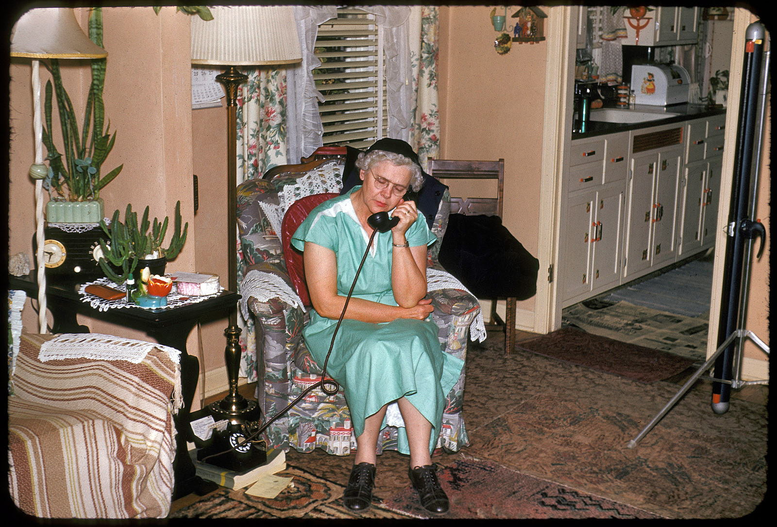 Another slide from Set 2 of found 35mm Kodachromes. On the wall, a September 1952 calendar; on the floor, an Indianapolis phone book. At the right, a projection screen where perhaps this very slide was shown after being developed. In the kitchen: many little decorative decals on the cabinet doors. View full size.