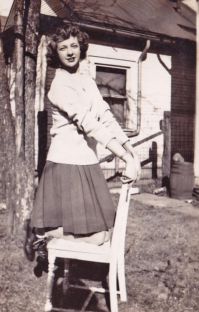 This is my grandmother Ruth. While her then-boyfriend was in the Pacific during WWII, she dragged a chair outside the house to take a series of photos like this one to send to him. I don't really understand why she wanted to be perched on a chair outside, but I'm just thankful that this is as risque as she ever got! View full size.
