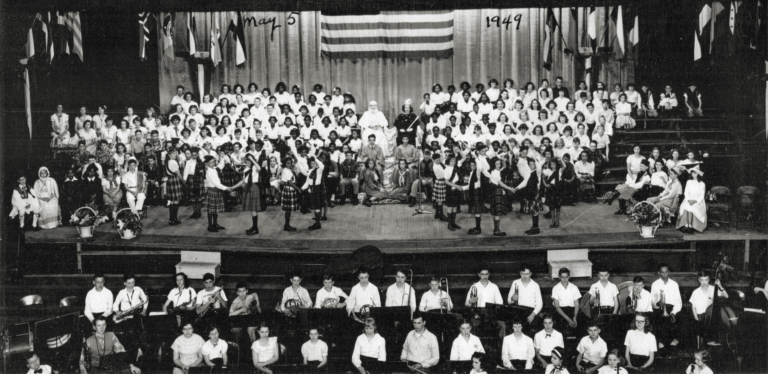 Youth concert held in Memorial Hall, Dayton, Ohio on May 5, 1949. My father was in the 7th or 8th grade at Jackson School and also a Boy Scout; he's sitting next to a Girl Scout (the foot of the microphone stand points to his right foot).  The group was made up of students selected from all the public schools. My father is unable to remember the theme for this concert. View full size.
