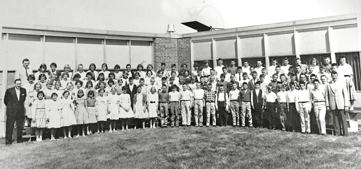 Sixth grade (I think) graduation from Cahill Elementary School, Edina, Minnesota. I believe it would have been 1959.  Principal Richard Dols is on the left. I am the squinter on the left, 2nd row, 2nd one in. The school was unfortunately torn down. View full size.