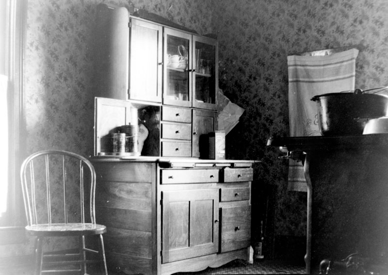 I believe that this was taken in Buffalo, NY about 1910.  I have no idea if it is my Grandmother's kitchen or that of a friend of theirs.  The Quaker Oats box (tin?) seen on the counter was replaced with the now familiar round package in 1915. Grandmother arrived in America in August of 1909.  Those are all of the clues that I have. View full size.