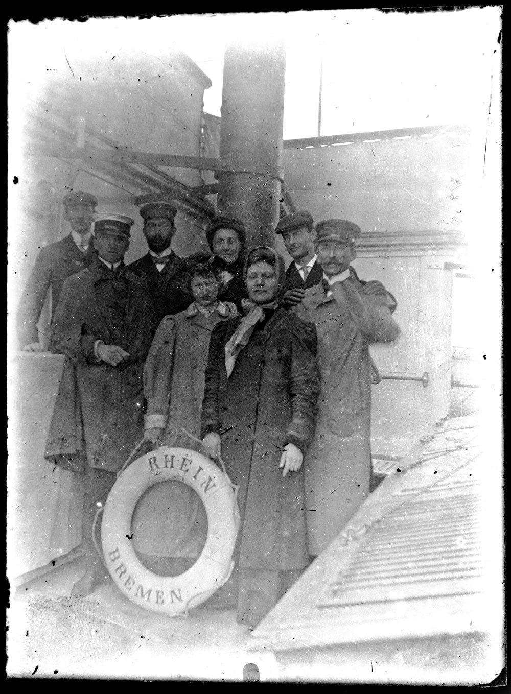 In 1907 my paternal Grandfather came to America aboard the ship Rhein which traveled from Bremerhaven (Bremen, Germany) to New York City.  The ship left on April 28th and arrived on May 13th.  The ship had been built eight years before and carried 369 second class passengers and 3082 in third class (there were no first class accommodations).

This picture was digitized from one of three 3x5 inch glass negatives that he took while onboard the ship.  All are a bit overexposed.  I believe that my Grandfather is standing at the left side of the back row.  The gentleman in front of Grandfather and the gentleman on the opposite end appear to be crew members.

Grandfather's arrival was at Ellis Island.  He left his fiancee in Germany and she followed him here two years later.  She arrived in Hoboken, NJ.  As she had no relatives here and since my Grandfather was not yet a naturalized citizen they were married onboard the ship by it's Captain in order to allow her to disembark. View full size.
