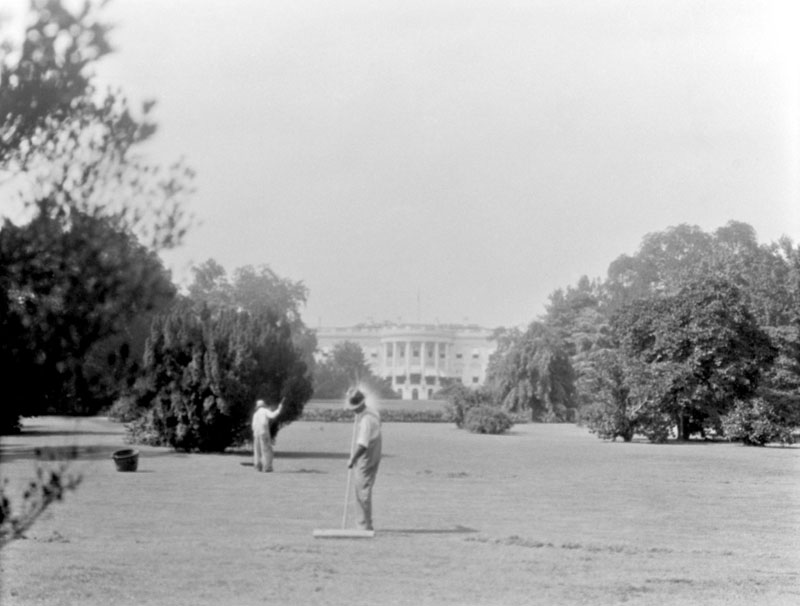 Washington DC, c. 1920's. They are using push brooms. Why? I have no clue about this "activity."  I imagine that the caretakers were just there in the way as my grandfather took this picture. View full size.