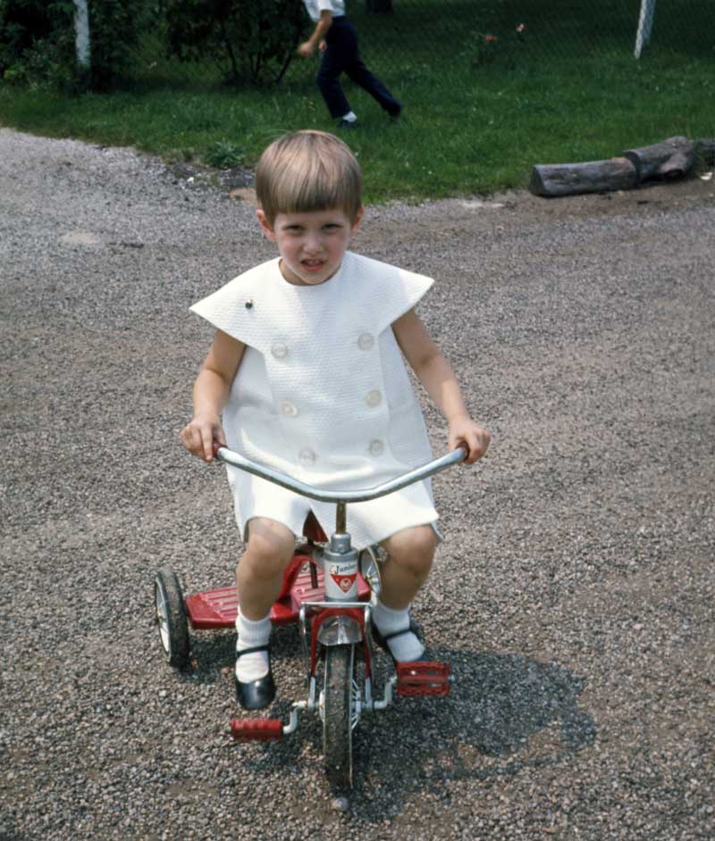 My sister Beth riding her AMF Junior (although from the wear and tear it could have been mine and passed down by three siblings before Beth got it). She's dressed in her Sunday best for the Baptism of our youngest brother in 1968. View full size.
