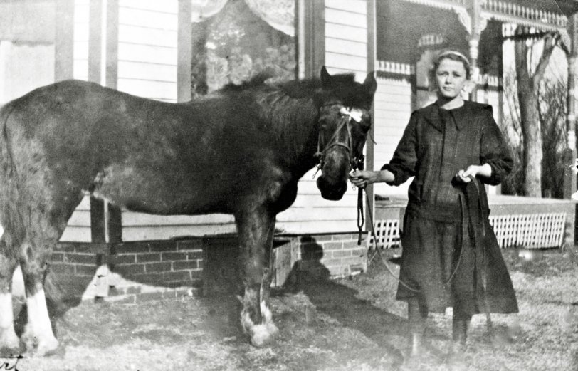 This is my father's mother at home in Muscatine, Iowa about 1922. She was born  Iona Gettert in 1900. A few years later she married Hans Frederick Larsen, seen in this photo with his Jewell Tea truck. View full size.
