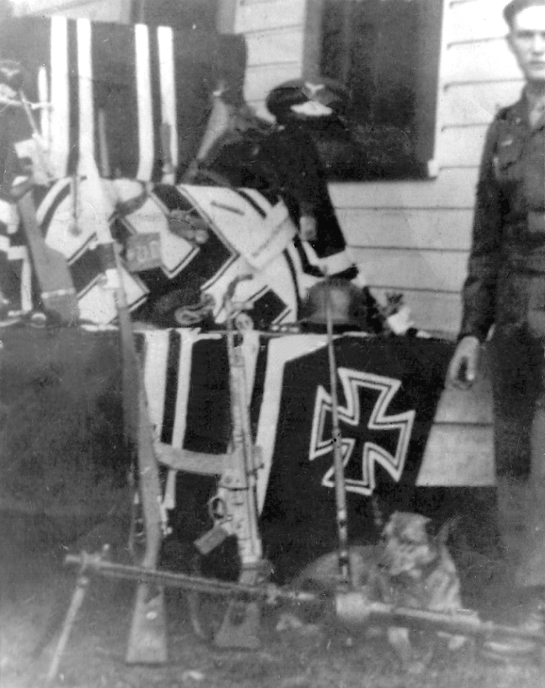 My dad served with the 82nd Airborne in WWII, and sent home an enormous batch of trophies, as seen in this photo taken on the front porch of our family farm after the war. Many of these guns, flags and uniforms were loaned to a museum in Fernandina Beach, Florida, and went astray. We were able to recover a few of them in the early 1970s and the automatic-weapon stamps from the ATF cost us a fortune; I believe it was $500 per gun. You should have seen it when the Naples police chief, my mom, two of my friends and I carried this stash of weapons into the Bank of Naples to store in their saftely deposit vault! They were all sold long ago, except for a Walther PPK I kept.

My dad even brought back that dog in the photo; her name was Beulah. View full size.