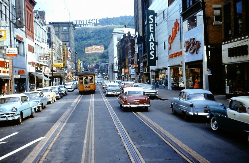 I took this scene of Main Street in Johnstown, PA on the afternoon of September 6, 1959.  The event was a part of the 1959 annual convention of the National Railway Historical Society that included a tour of the city's remaining five streetcar lines.  All were slated for conversion to trolley bus the following June.  Main Street at the time appeared to be prosperous, but in the ensuing  60 years, Johnstown has been practically rendered a ghost town, having lost its steel industry and suffered a devastating flood.  Car 350 is  today preserved at the Pennsylvania Trolley Museum at Arden, PA.

 A subsequent submission will depict the closing day ceremonies held June 11, 1960.

35mm Kodachrome slide by William D. Volkmer