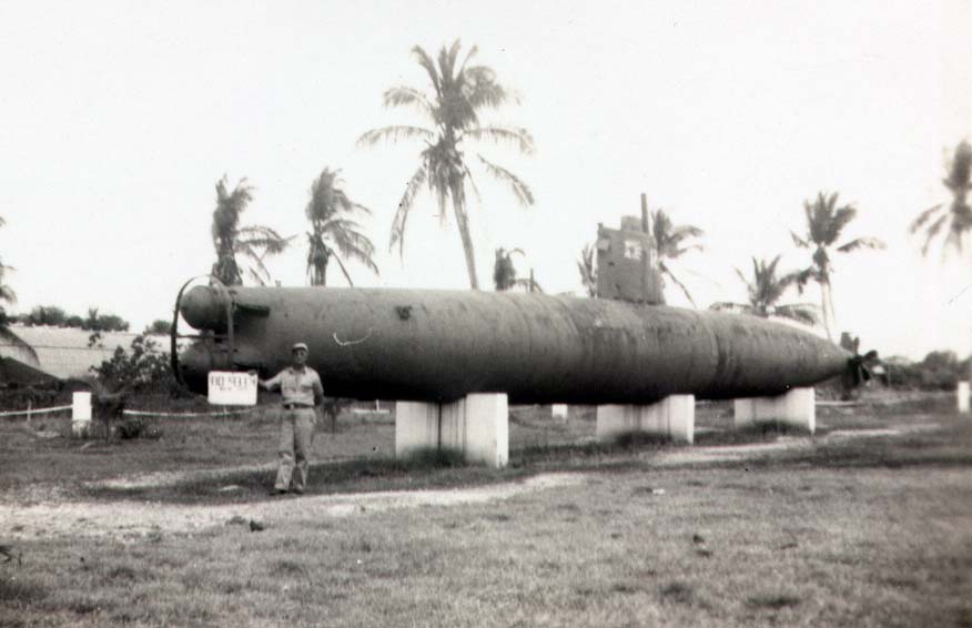 My grandfather Alexander "Jack" Davis in Guam on business, posing with a Japanese mini sub. March 21, 1947.