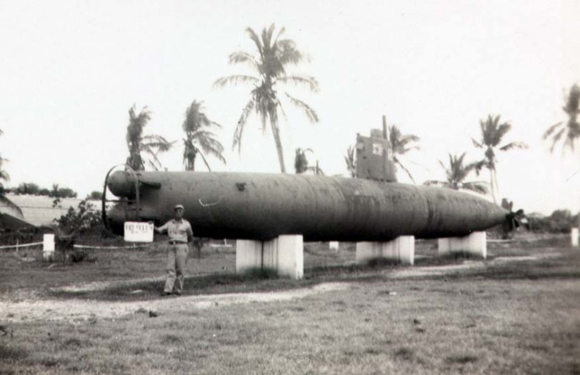 My grandfather Alexander "Jack" Davis in Guam on business, posing with a Japanese mini sub. March 21, 1947.
