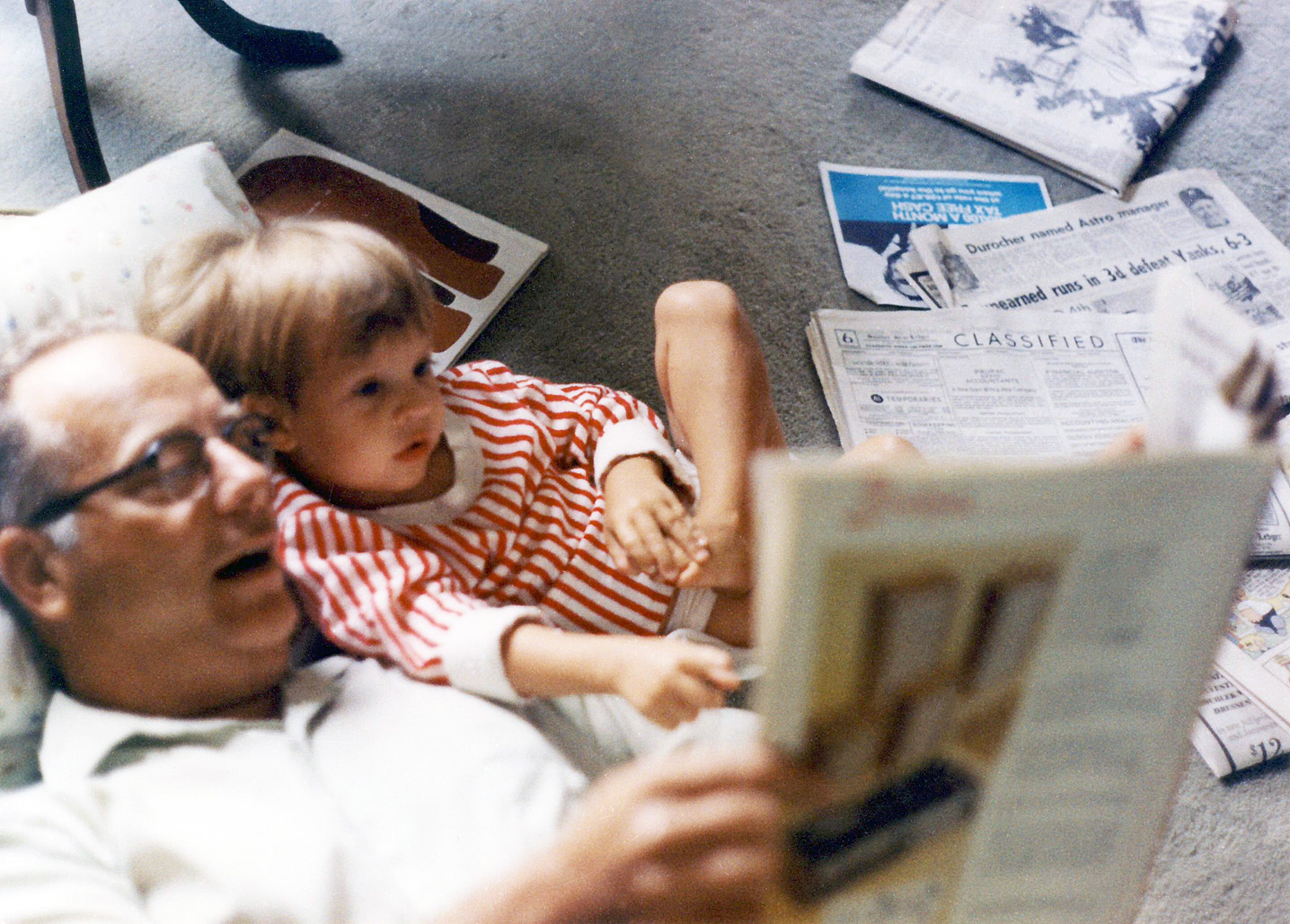 My dad shares the comics with my son James on a spring Sunday morning in 1971 in Mom and Dad's home in Chatham, New Jersey. The Newark News View full size.