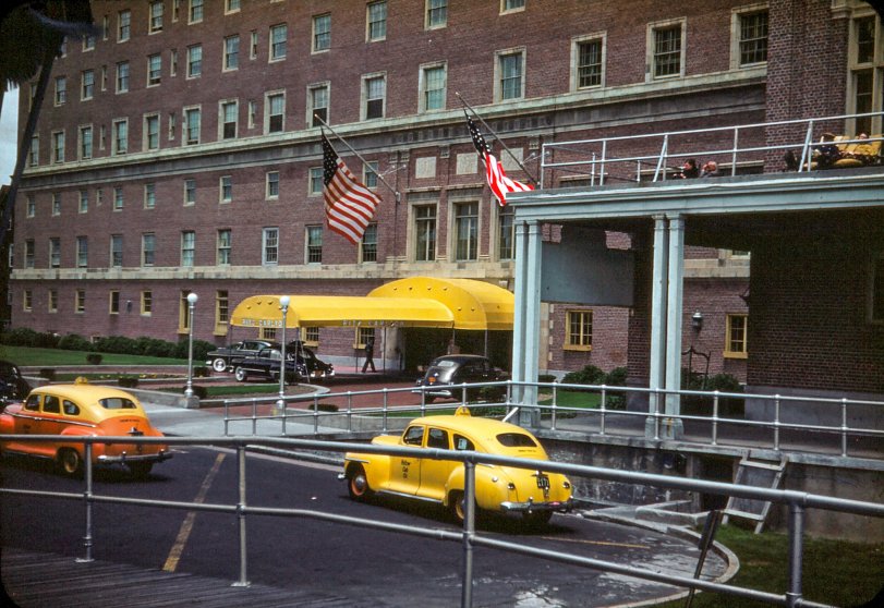 One of my grandfather's Kodachromes from the 1950s while he was in Atlantic City for a convention. This is the Ritz Carlton and you can see a few people lounging on the balcony overlooking the ocean and the drop-off area. There appears to be a valet parking area with some very important looking black sedans. View full size.
