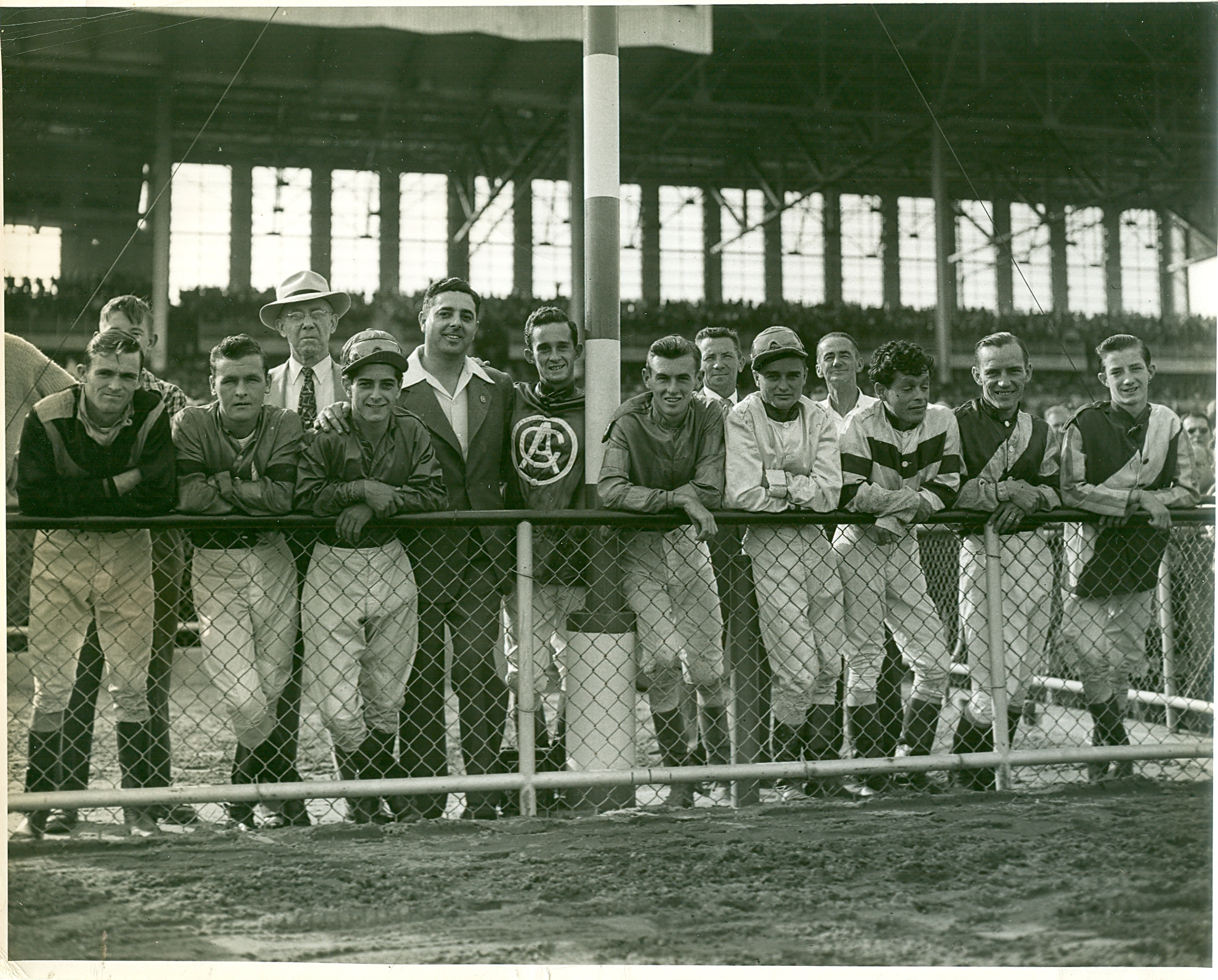 The Jockeys are looking at President and Mrs. Eisenhower during their visit to Belmont Park. View full size.