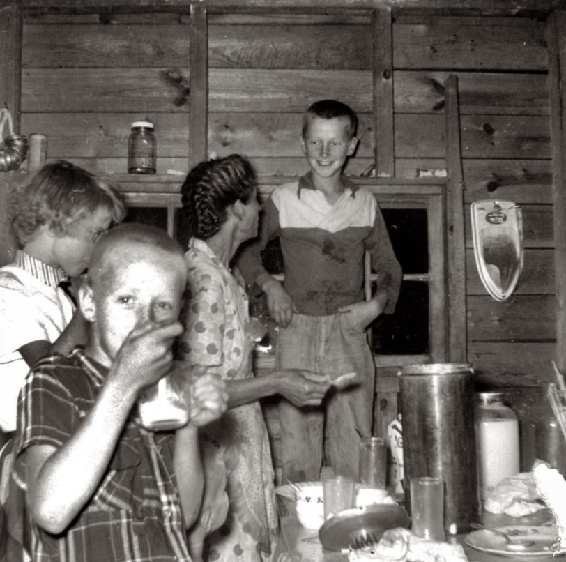 July 1955 - Cordova, Alabama. My grandmother, Bessie Johnson, makes homemade ice cream for the kids. That's my dad, Sam Johnson, grinning from ear to ear standing on the chair in the background. That's uncle Gene in the front and Aunt Betty on the far left.
