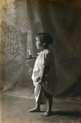 A studio portrait of Josephine K. Pernet (1913-1928), daughter of Emile B. and Ada R. Pernet of Phoenixville, Pennsylvania.  Sadly, Josephine died young of tuberculosis.  Note the retouching on the candle to give it the appearance of being lit. View full size.