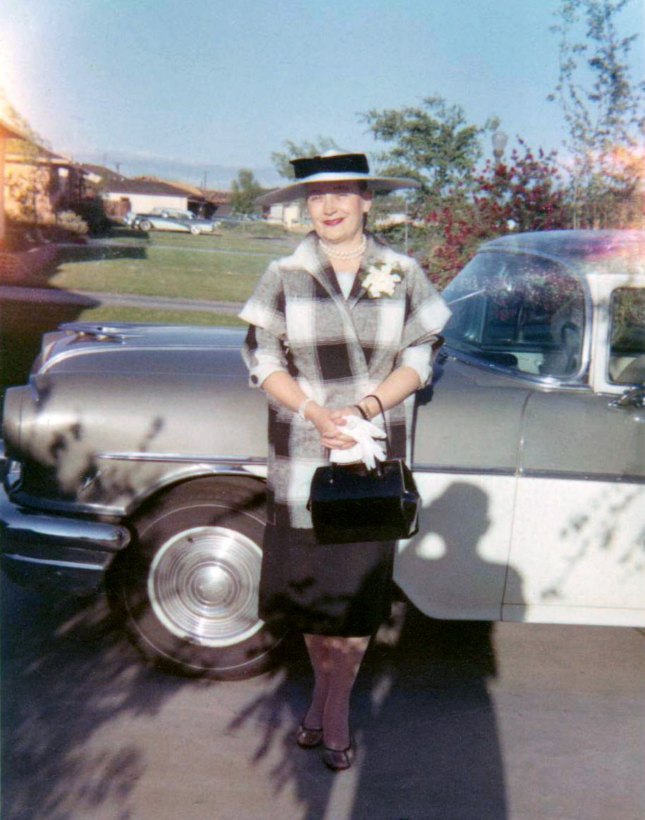 My wife's aunt, June O'Neill, in her Sunday best, approximately 1962. Taken in her front yard in the River Park neighborhood in Sacramento, California.  We now live in this house; the tree in the background is over 75 feet high now. View full size.