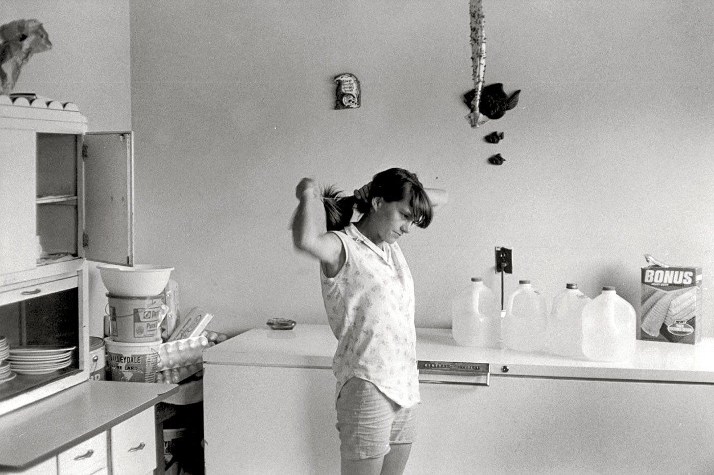 "Woman in kitchen tying her hair." Another of William Gedney's images from 1972 of the Cornett family in Leatherwood, Kentucky. [Link 1] [Link 2]. William Gedney Photographs and Writings Collection, Duke University. View full size.