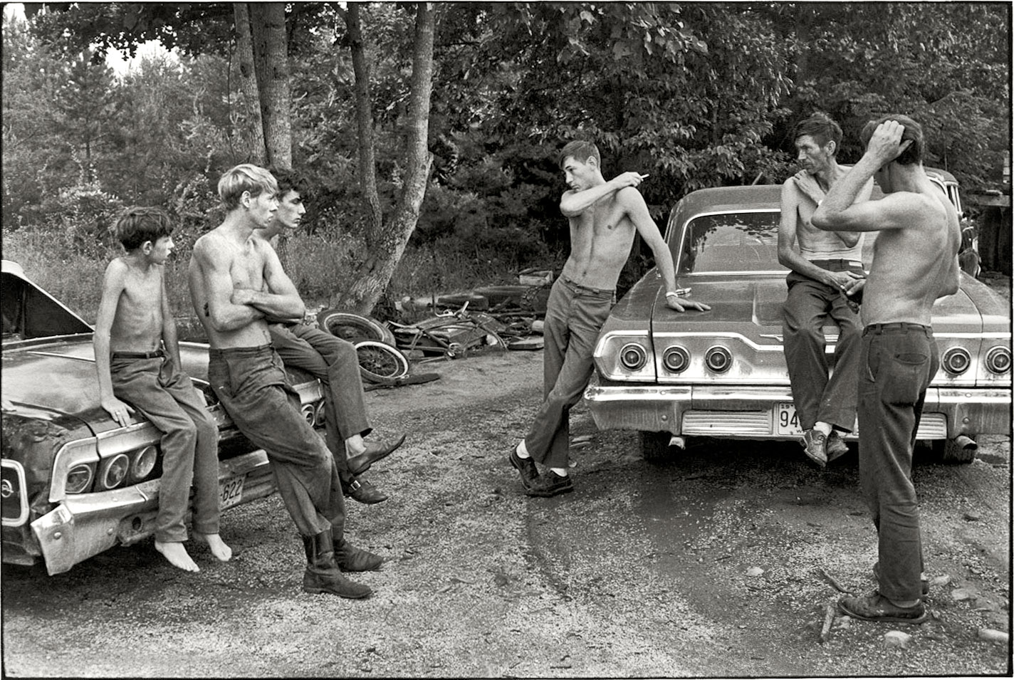 "Cornett family. Leatherwood, Kentucky, 1972. Men and boys without shirts sitting and standing around two cars." Willie Cornett (seated, right) and some of his 12 children. 35mm negative by William Gedney (1932-1989). From Duke University's  Gedney Collection, encompassing some 5,000 pictures taken from the 1950s through the early '70s. Do we want to see more? View full size.