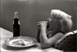 Leatherwood, Kentucky, 1972. "Cornett family. Little boy taking a bite of food at the table." Print from a 35mm negative by William Gedney. Gedney Photographs and Writings Collection, Duke University. View full size.