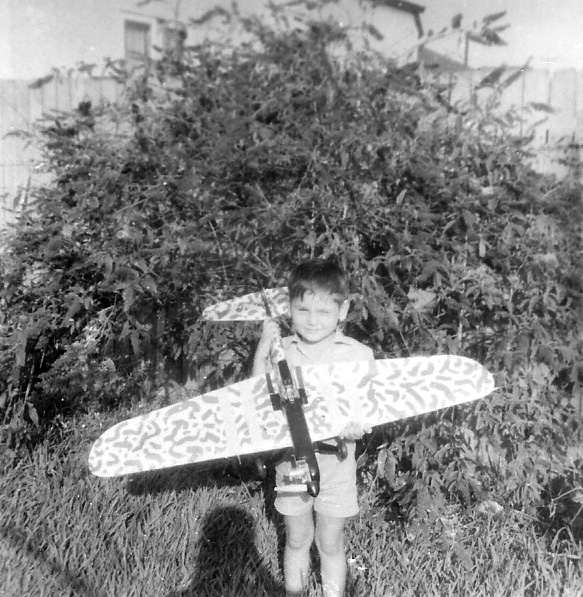 I love the smell of model aeroplane fuel in the morning. 1969, me holding my brother's latest creation, a model of a Japanese Kawasaki fighter, I believe, a fly-by-wire, silk and balsa wood model powered by a Enya motor. I often went to the city with my brother to Hobbyco to buy parts and wonder at the miniature marvels on display. This plane met its demise in a loop the loop that ended with the plane losing the undercarriage and suffering wing damage. My brother still has the motor, which powered a few more planes during his youth.
