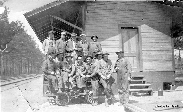 This photo was shot sometime in the late 1920's at a depot of the Louisville &amp; Nashville Railroad (the L &amp; N ..... "the old reliable").  Those in the photo are a "Bridge Gang" employed by the L &amp; N, whose work was that of maintaining, repairing and building railroad bridges.  My father, Hylott L. Armstrong, Sr., is in the photo, i.e. the 4th person from the left of the seated row.  They are seated on what was known to railroad employees as a "motor car" ..... a gasoline powered utility rail vehicle used to transport workers, tools and materials to and from job sites.
