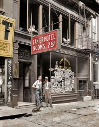 Colorized from a Shorpy original. 

The Lanier Hotel & Fuerst Bros. Restaurant, 15 Bowery NYC
Colourisation from a black and white photo
Tuesday, July 5th, 1921, New York, United States of America, by George Grantham Bain's Bain News Service

Proprietors Alex and Sigmund Fuerst stand outside their hotel and associated restaurant in what is now modern day Chinatown in New York City, opposite the old Bowery Theatre. The Fuerst family, consisting of five brothers, owned several restaurants along the popular theatrical strip along the Bowery, including the now demolished address at 15 Bowery, 109 Bowery and 221 Bowery, which has very similar architectural detailing to the buildings on 15 Bowery.

The surrounding area in what is now Chinatown attracted residents and transient visitors at the lower end of the economic ladder, staying in numerous lodging houses, or the more pejorative 'Flop House', where for 5 cents, one could literally 'flop over' in quarters about the size of a standard office cubicle. The Lanier Hotel as pictured was more expensive (although very cheap by modern pricing), offering a small private room with clean sheets, somewhere between a capsule hotel and a bed and breakfast. The Lanier Hotel eventually closed down, although the Fuerst brothers remained in the substantially more profitable restaurant business.

With thanks to the Fuerst family for detailed information regarding this image. View full size.