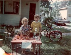 My brother Patrick and I selling odds and ends at our lemonade stand in Potsdam, NY, though I think it was actually Kool-Aid. My parent's 1964 Mercury Monterey is parked in the driveway. It had a power back window (not just side windows). Some kid came by to buy our stuff who had a banana seat on her bike. I got one later on. We spent all summer barefoot. View full size.
(ShorpyBlog, Member Gallery)