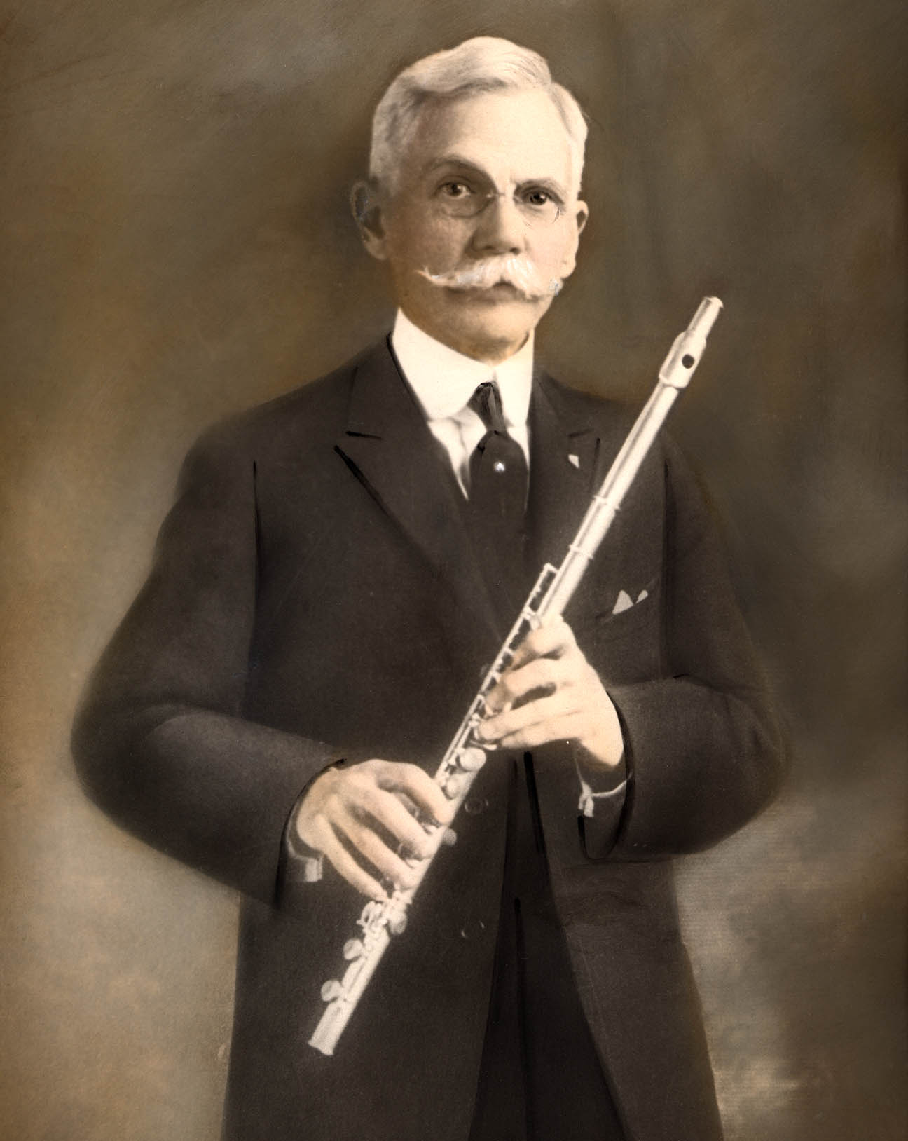 My great-grandfather Linton B. Moore was very proud of his "silver" flute.  So proud, he had his formal portrait taken while holding it.  I'd estimate this photo as being taken around 1910, most likely in southern California.

Don Hall
Yreka, CA