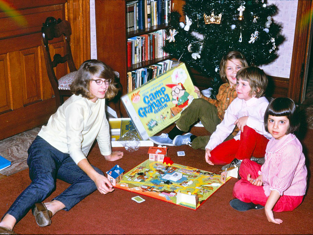 This photo was taken 1966 in Slatington, PA, at the home of my grandmother. On Christmas day we would gather for gifts and dinner. Of course the special feature of this photo is one of the more memorable gifts, the board game Camp Granada. Note the ornaments on the tree, not the traditional glass balls and lights, but church symbols which I believe were called Chrismons. My father took this photo, which was processed into a slide. The slide along with thousands of others sat in its case for years at the back of the coat closet. Just last year dad had them digitally transposed. What a gift. View full size.